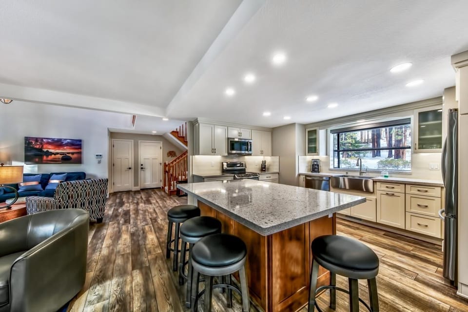 Your open-concept kitchen flows seamlessly into the living area, creating the perfect space for cooking and gathering with granite countertops and modern appliances.