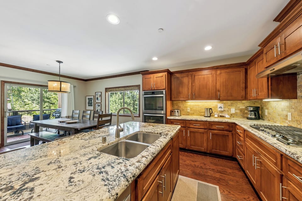 Your gourmet kitchen features granite countertops, warm wood cabinetry, and stainless steel appliances for culinary adventures.