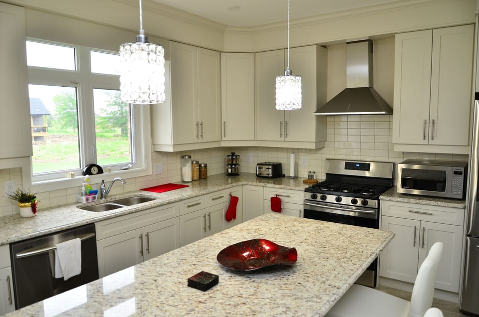 Huge kitchen with top of the line appliances, breakfast bar and dining nook.