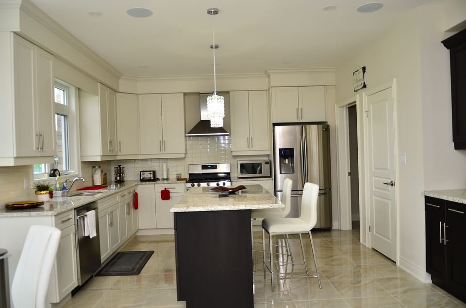 Huge kitchen with top of the line appliances, breakfast bar and dining nook.