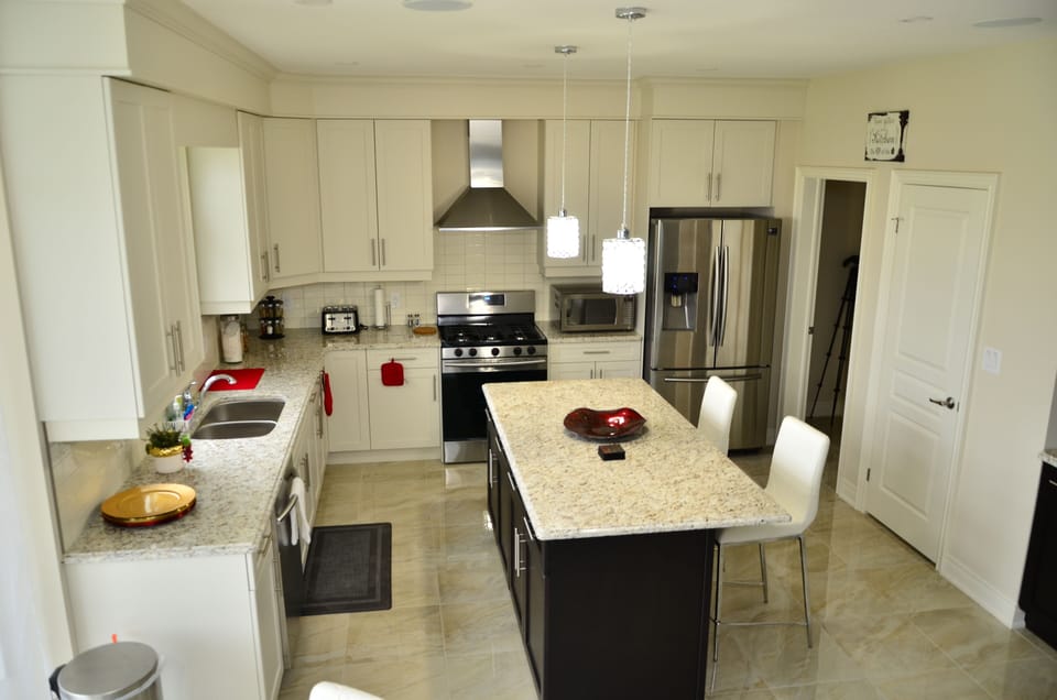 Huge kitchen with top of the line appliances, breakfast bar and dining nook.