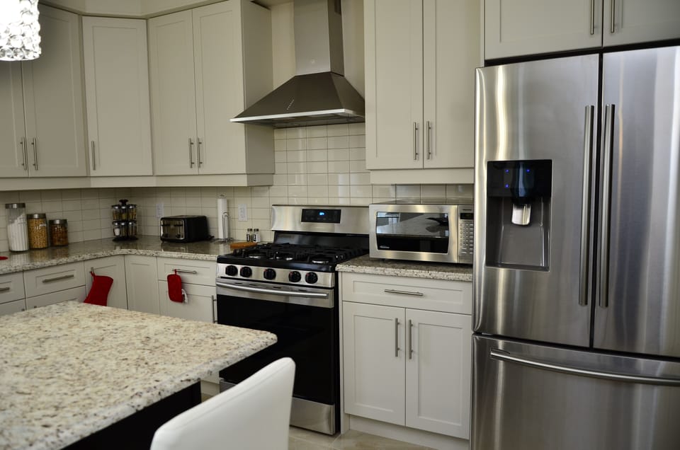 Huge kitchen with top of the line appliances, breakfast bar and dining nook.