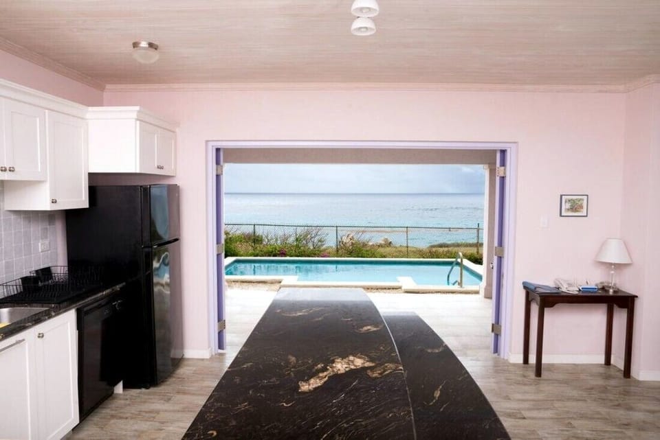 Kitchen opens up to terrace, pool and sea view