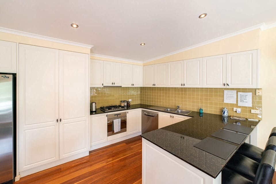 Upstairs culinary delight: Large, modern kitchen, stylish and well-equipped for gatherings.