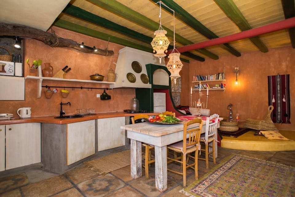 Fully equipped kitchen with large wooden table which also serves as a secondary cooking bench