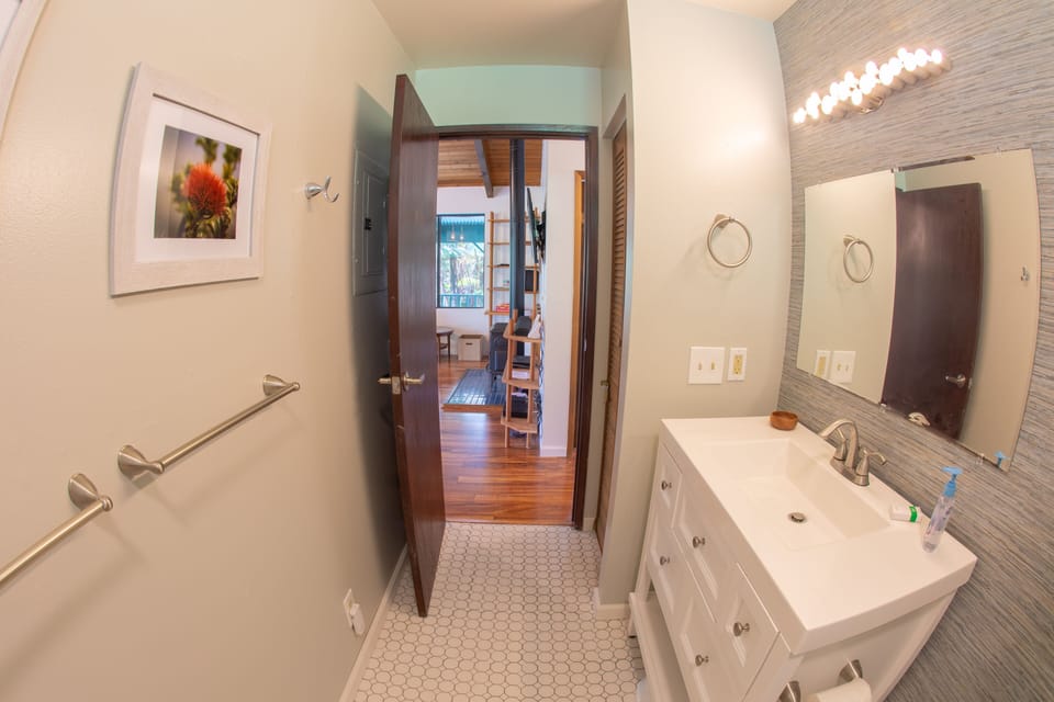 Bathroom is centrally placed between living are and bedrooms for accessibility