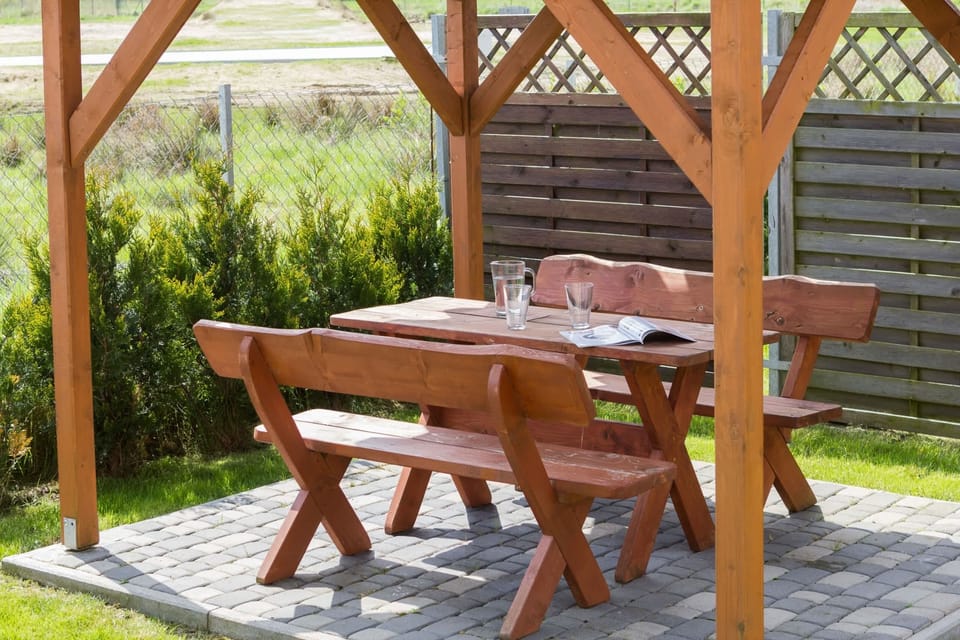 Located outside, bench with table. A unique place for outdoor dining.