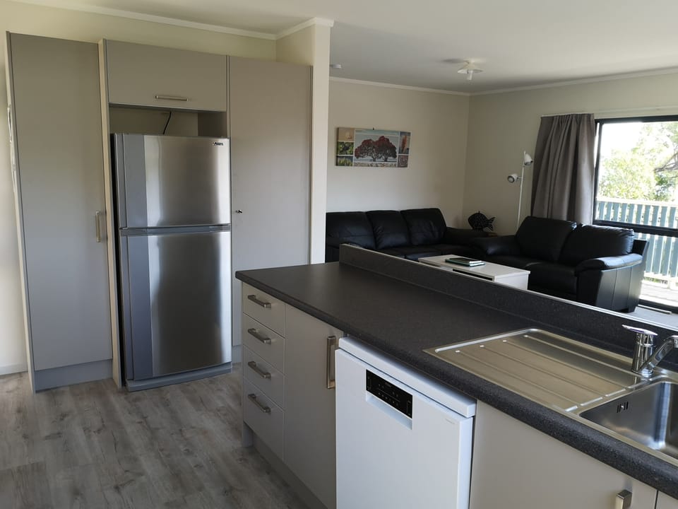 Cottage Kitchen.  Full size fridge/freezer. Dishwasher with view to the beach.
