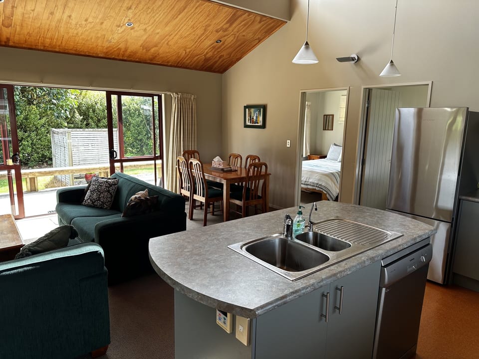 Open plan living and kitchen with double slider leading to deck