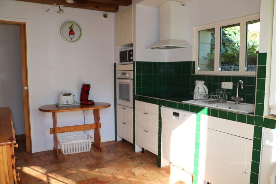 The kitchen overlooks the garden and the pool It's fully equipped