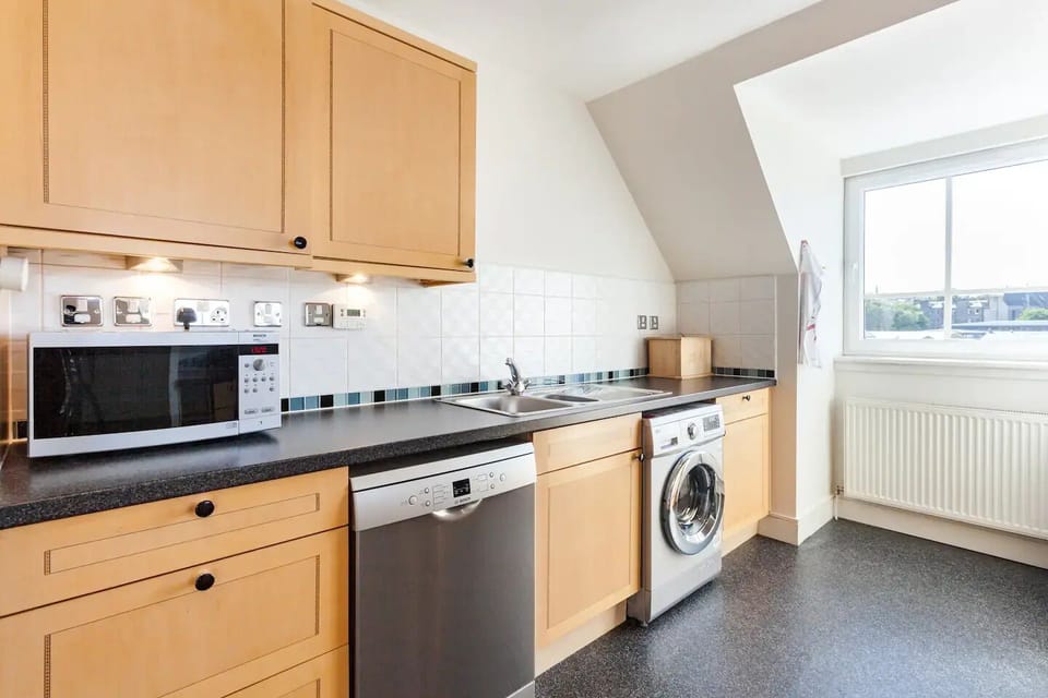 The kithcen includes a microwave, dishwasher and washing machine.