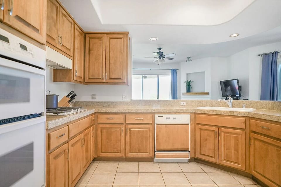 Fully equipped kitchen with essential cookware and dishware (styles and sets may