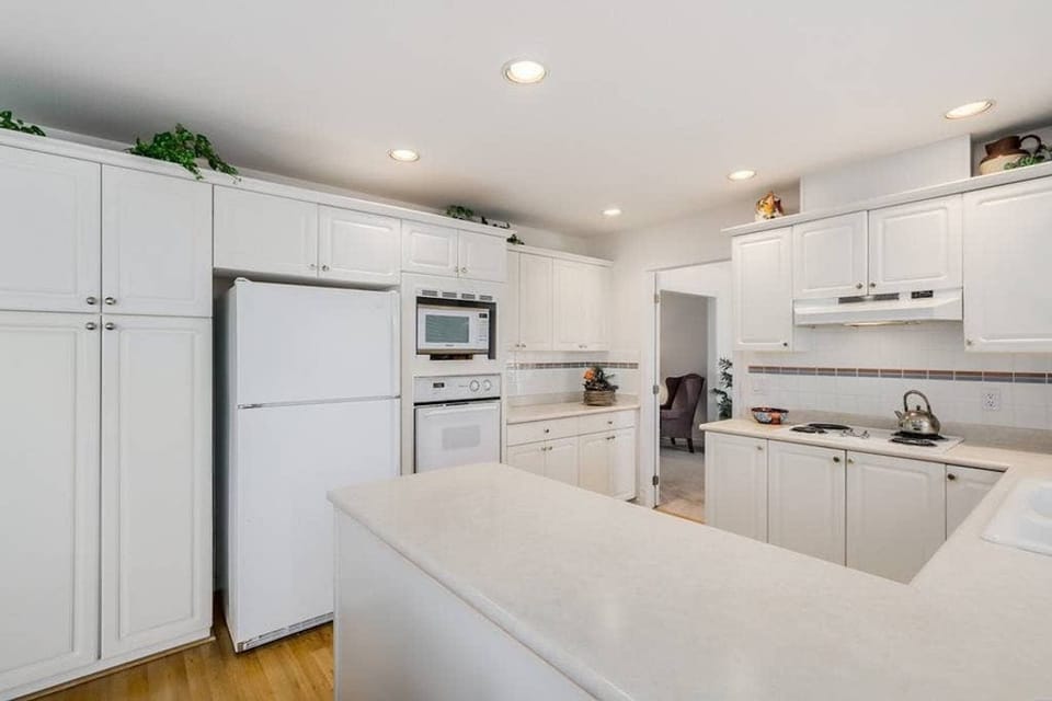 Kitchen with fridge, microwave, and oven.