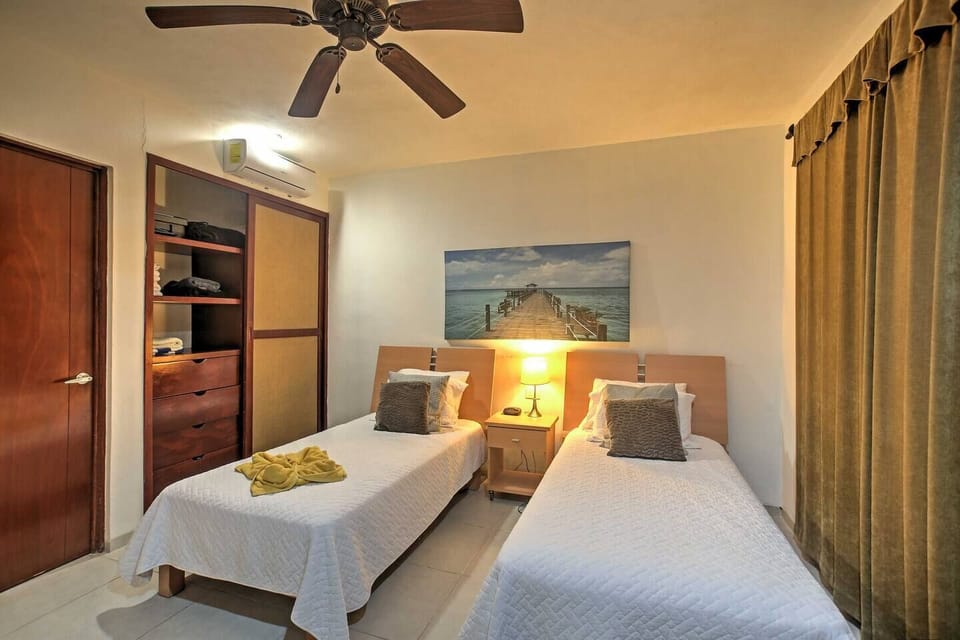 Guest bedroom with two full beds. Safe on the left above drawers (not pictured).