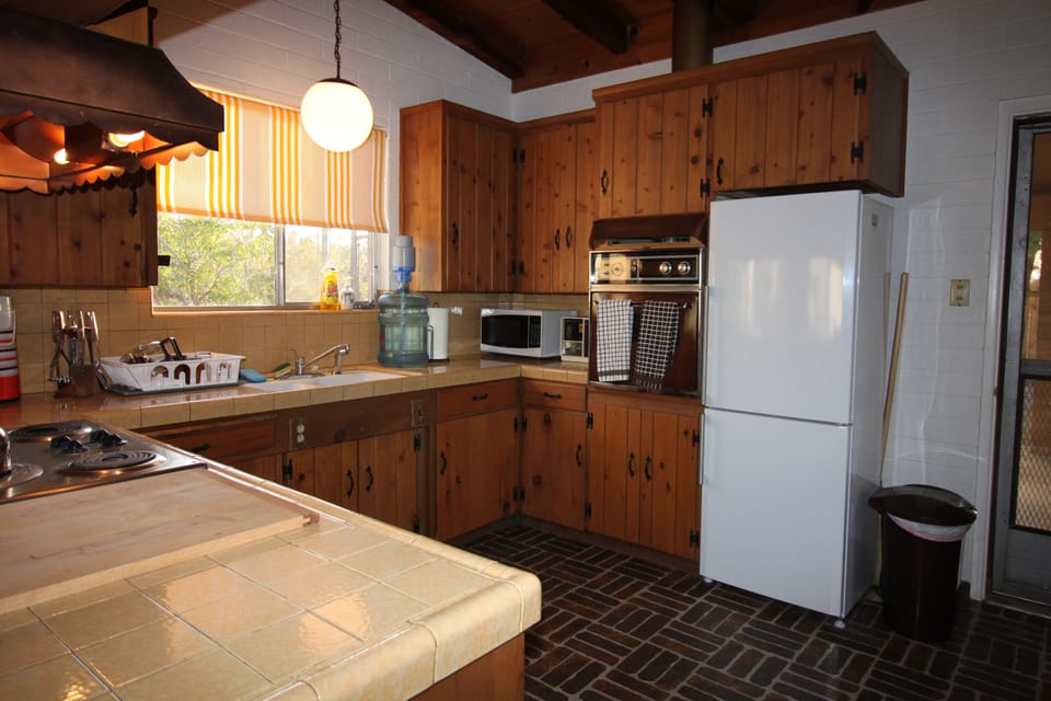 The kitchen retains the original cabinetry and tile work for time traveling.