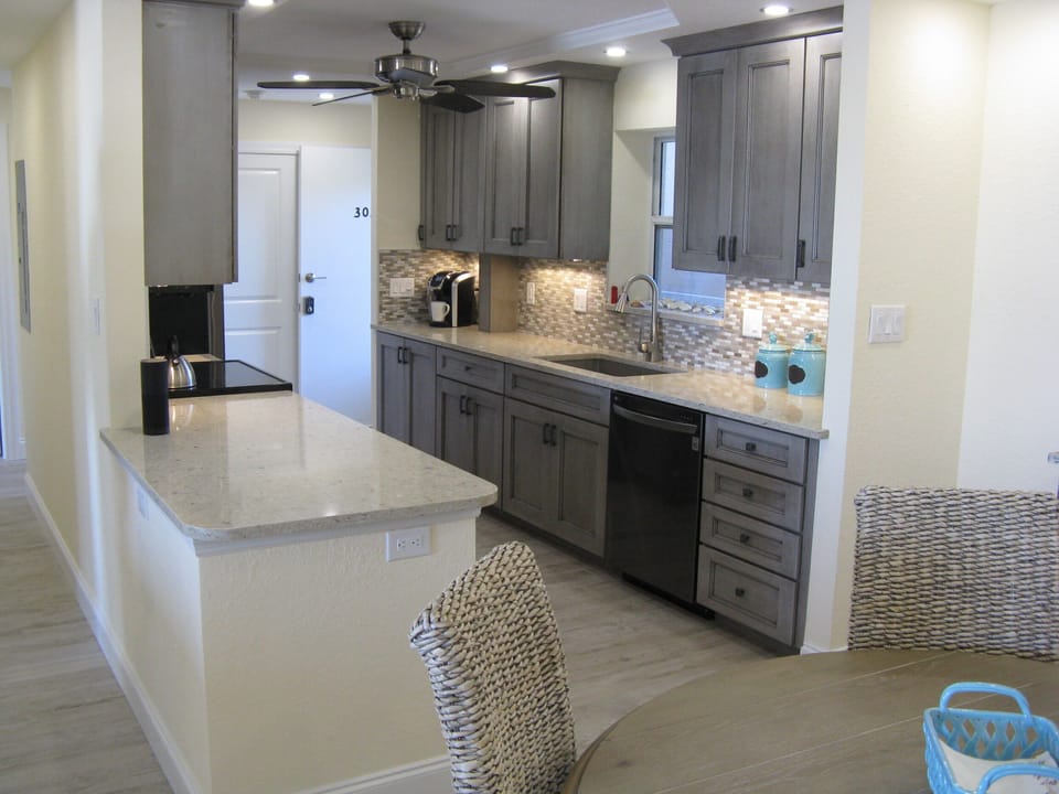 Peppercorn cabinets with top quality black stainless kitchen appliances.
