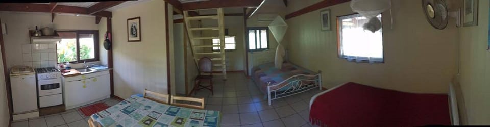 Panoramic view on double bedroom, single room, kitchenet, dining table staircase