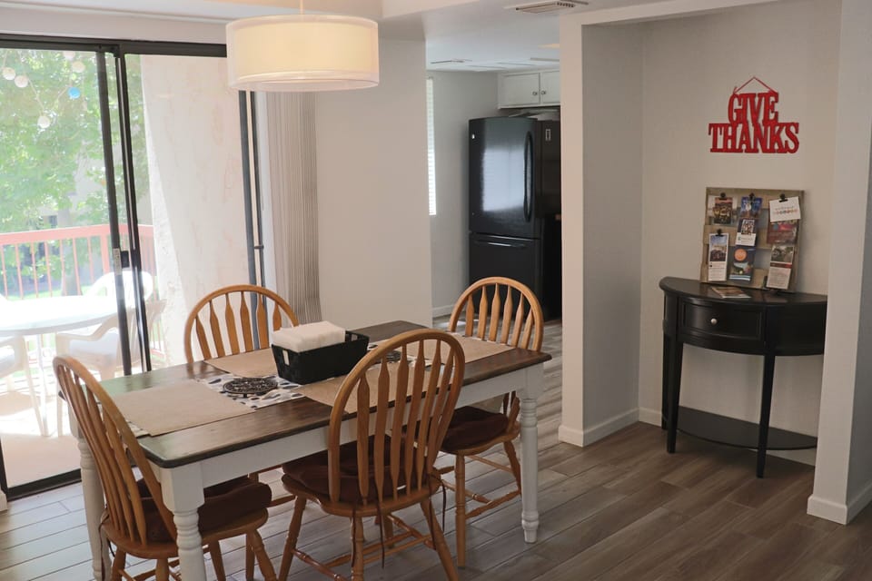 Kitchen table allows views of the greenbelt through sliding door.