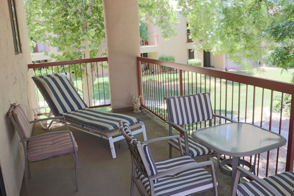 Large balcony overlooks beautiful heated pool and hot tub area.