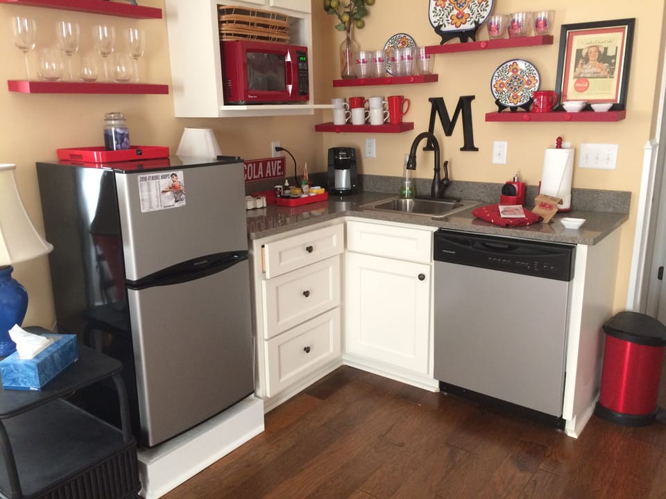 Kitchenette with frig, dishwasher, sink, microwave, coffeemaker, dishes, toaster