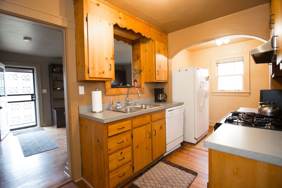 Another view of kitchen and bit of family room with back door