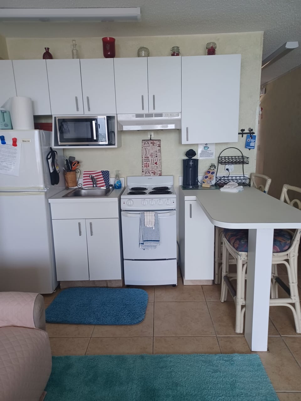 Fridge, microwave, oven, mini keurig, and breakfast bar with ocean view