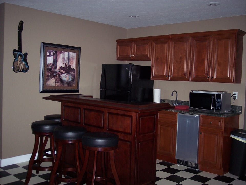 Bottom Floor Bar with, Refrigerator, microwave and sink.