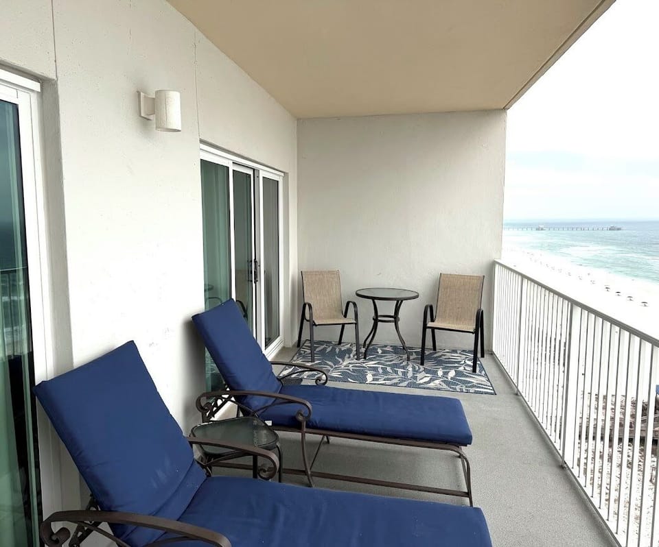 Balcony overlooking Beach.  2 Lounge Chairs, 4 Sitting Chairs and Tables