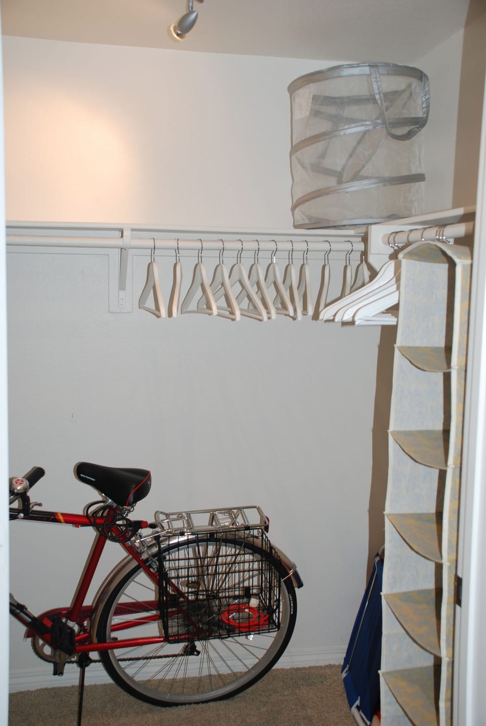 Walk in closet off of Master bathroom with another bicycle and beach equipment.
