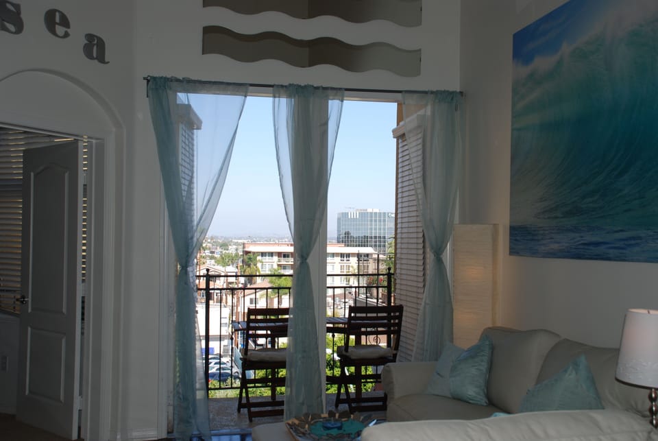 Downstairs balcony with city views and gas BBQ grill.