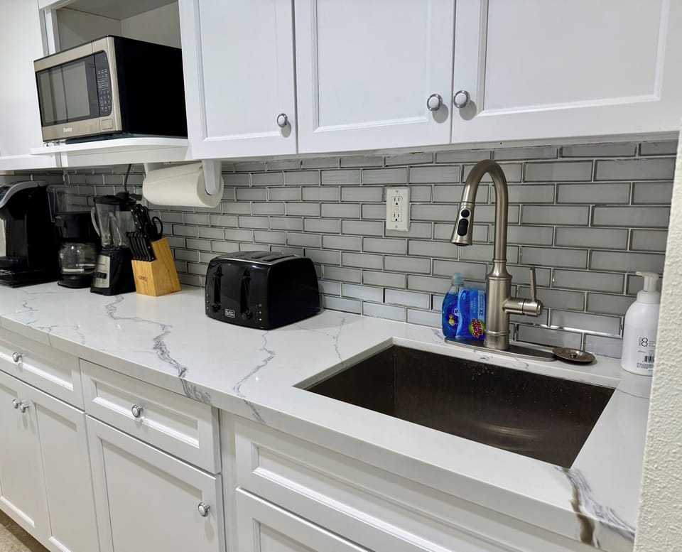 Kitchenette with microwave, hotplate, keurig, mr coffee, toaster, balcony grill