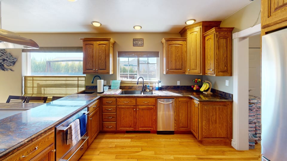 Designer kitchen with three sinks double dishwasher & granite counter tops.  