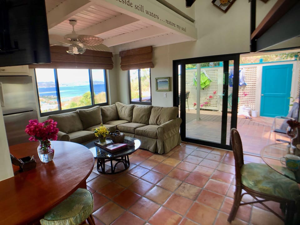 Main floor view, comfy couch, showing beach chairs on outside deck
