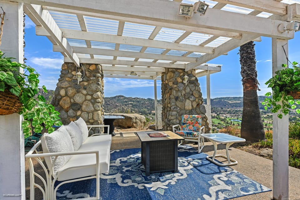 Pool sitting area with an outdoor shower and a nice fireplace. Enjoy the breeze!