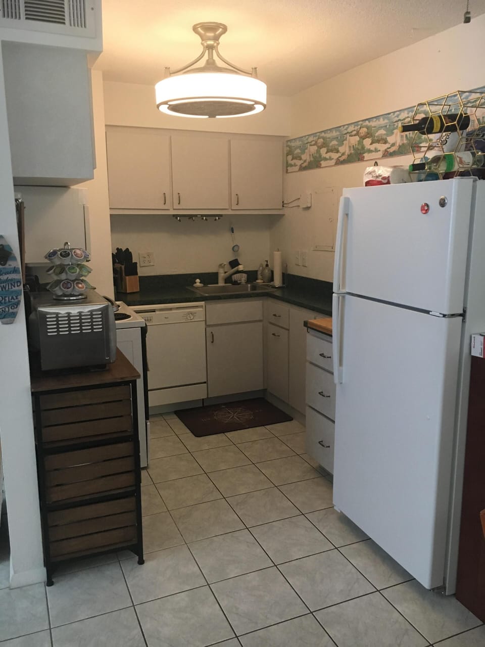 Kitchen with full sized appliances, including dishwasher.