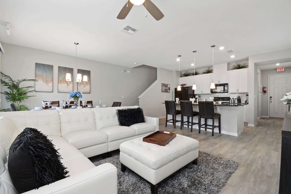Open living area with a white sectional and media wall-bright, modern, and perfect for gatherings.