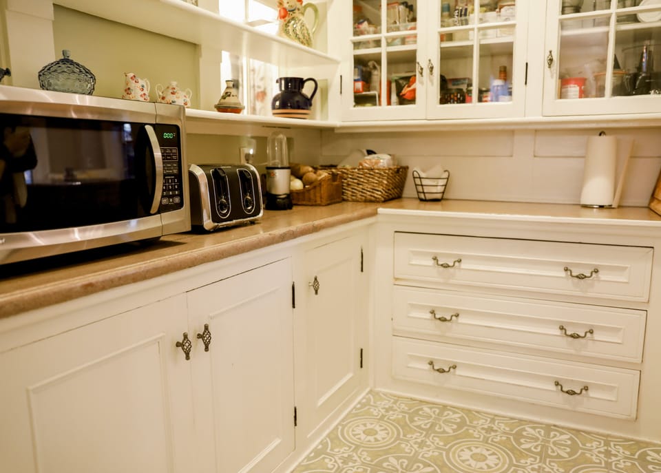 A well stocked pantry with coffee, tea, espresso maker, blender, toaster
