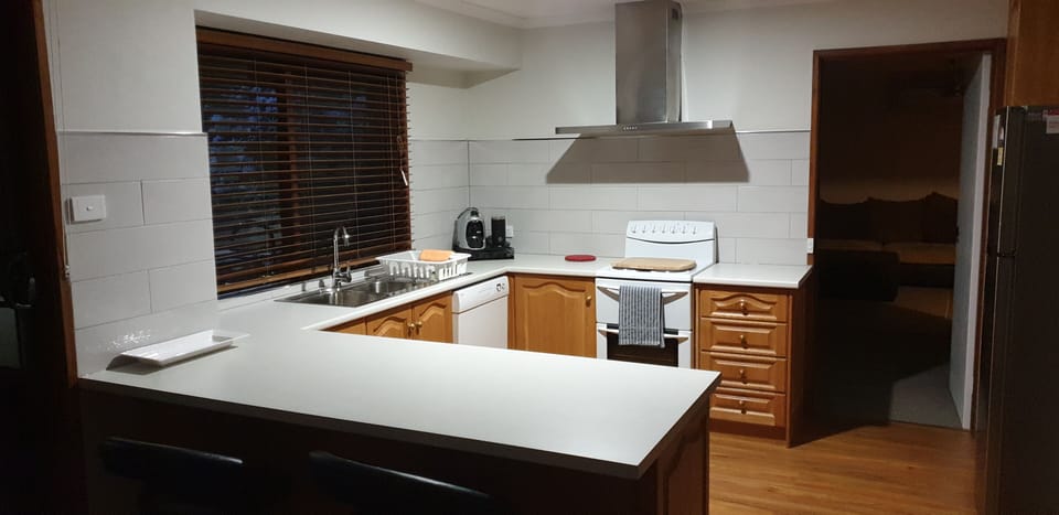 Kitchen with dishwasher, dishwasher tablets, microwave, fridge 