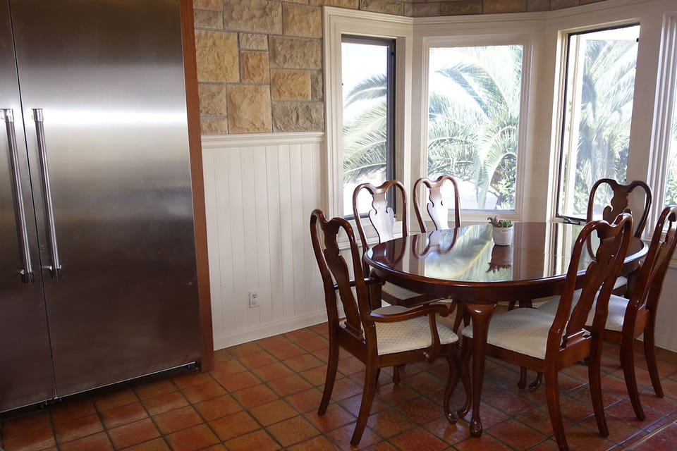 Kitchen with oversized fridge, dining table