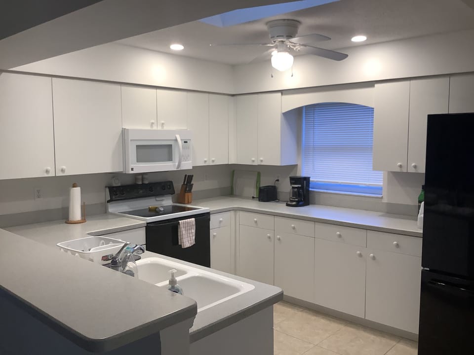 Kitchen has electric range, refrigerator, dishwasher, coffee machine and more..