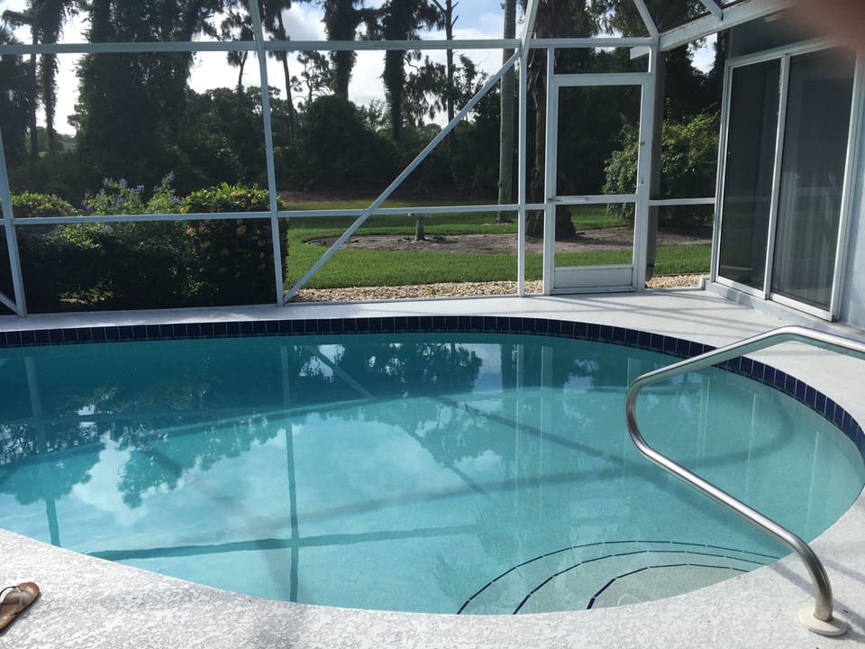 Kidney shaped screened in pool. Always well maintained. Heated.