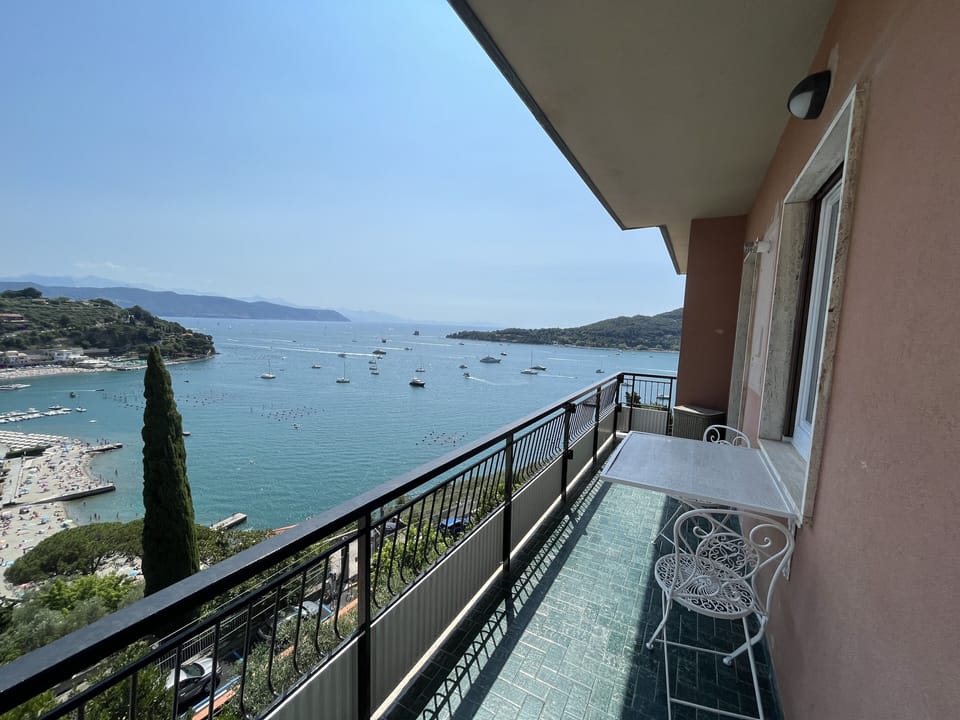 Long terrace with dining table overlooking the sea