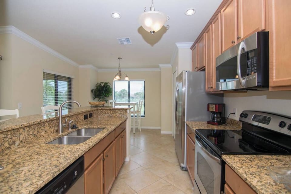 The Kitchen Features Granite Counters and a Bar Height Counter