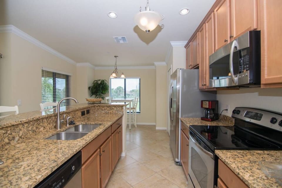 The Kitchen Features Granite Counters and a Bar Height Counter