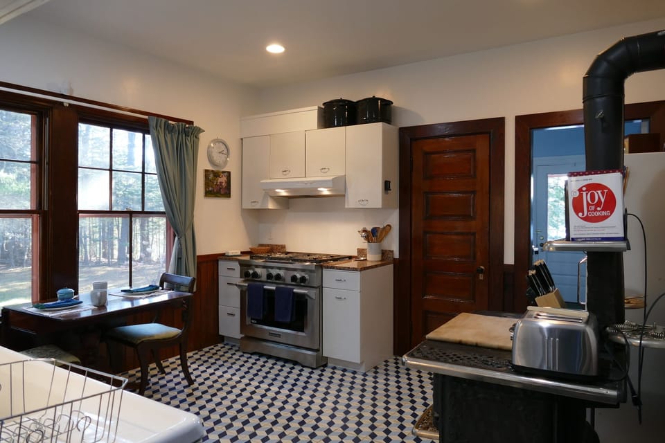 Kitchen with a  6 burner  gas stove top and a standard and convection oven.
