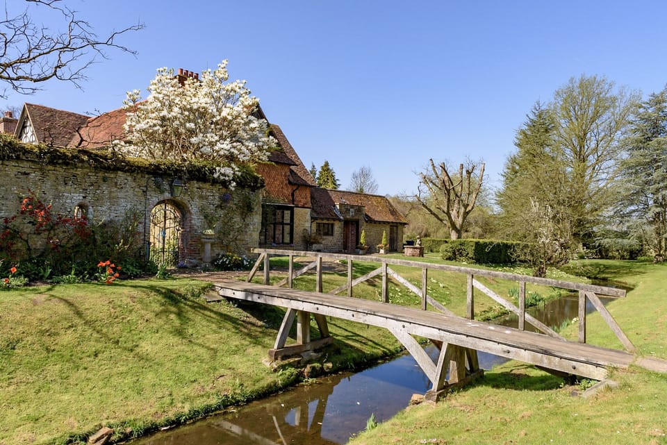 Access to the house via single handrail bridge over the moat