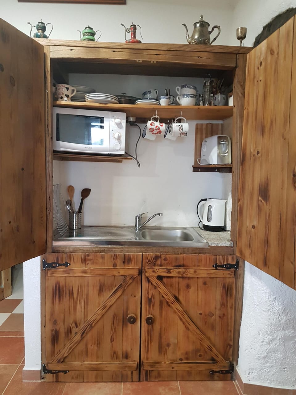 kitchenette with small fridge below