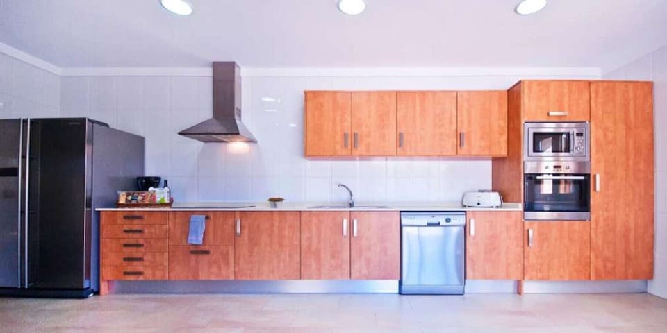 Nice wooden kitchen equipped with appliances