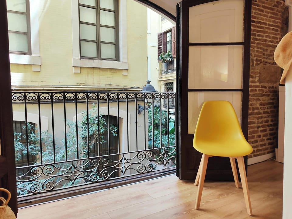 Enjoy fresh air and views from the balcony facing the charming Passatge Sert.