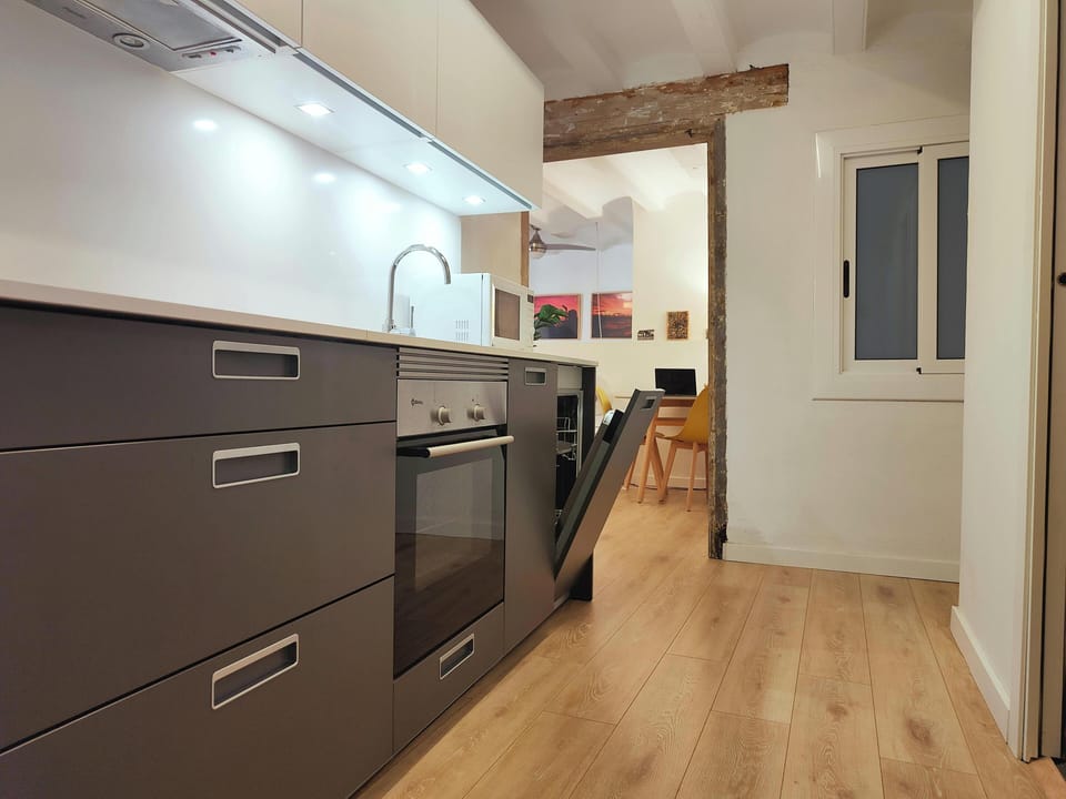 Enjoy cooking in a fully equipped kitchen featuring a dishwasher, induction plaque, oven, toaster and coffee maker